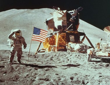 neil armstrong salutes with american flag and spaceshift behind